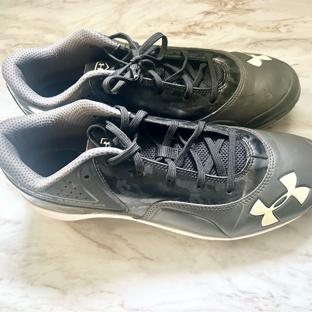 Under Armour Black and White Athletic Shoes cleats.